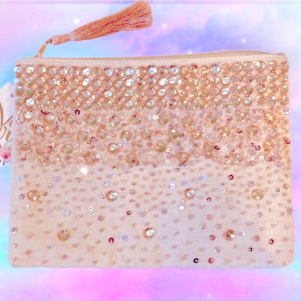 An Anthropologie, cream colored, sequined pouch.